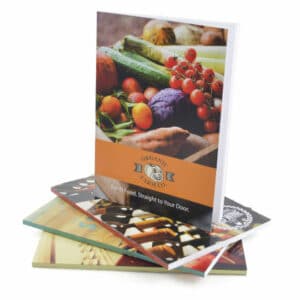 Various A5 williams promotional notepads, stacked up, with full colour printed cover on a white background