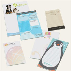 A range of promotional printed notepads on a grey background